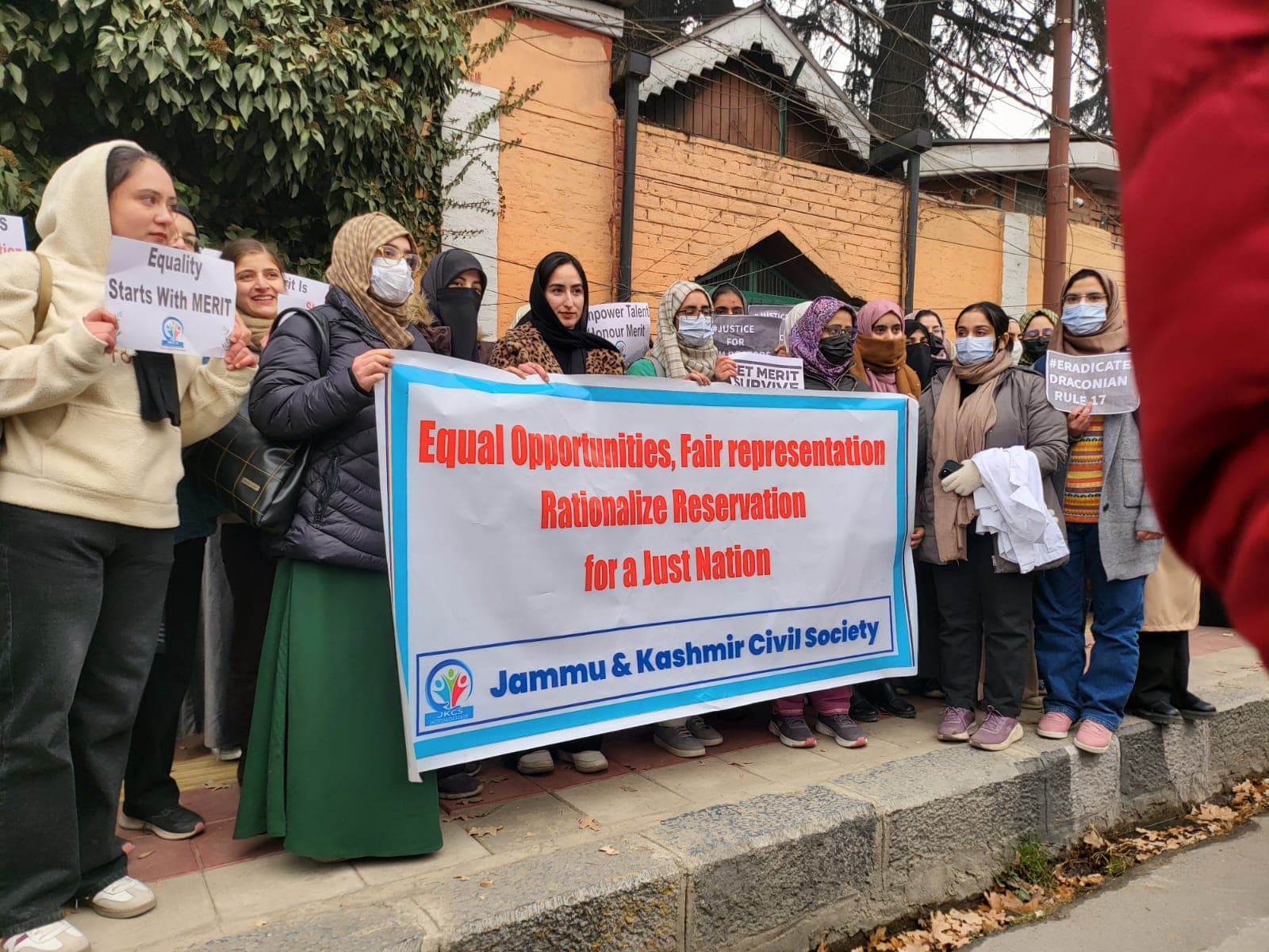 Members holding banners at a JKCS advocacy demonstration